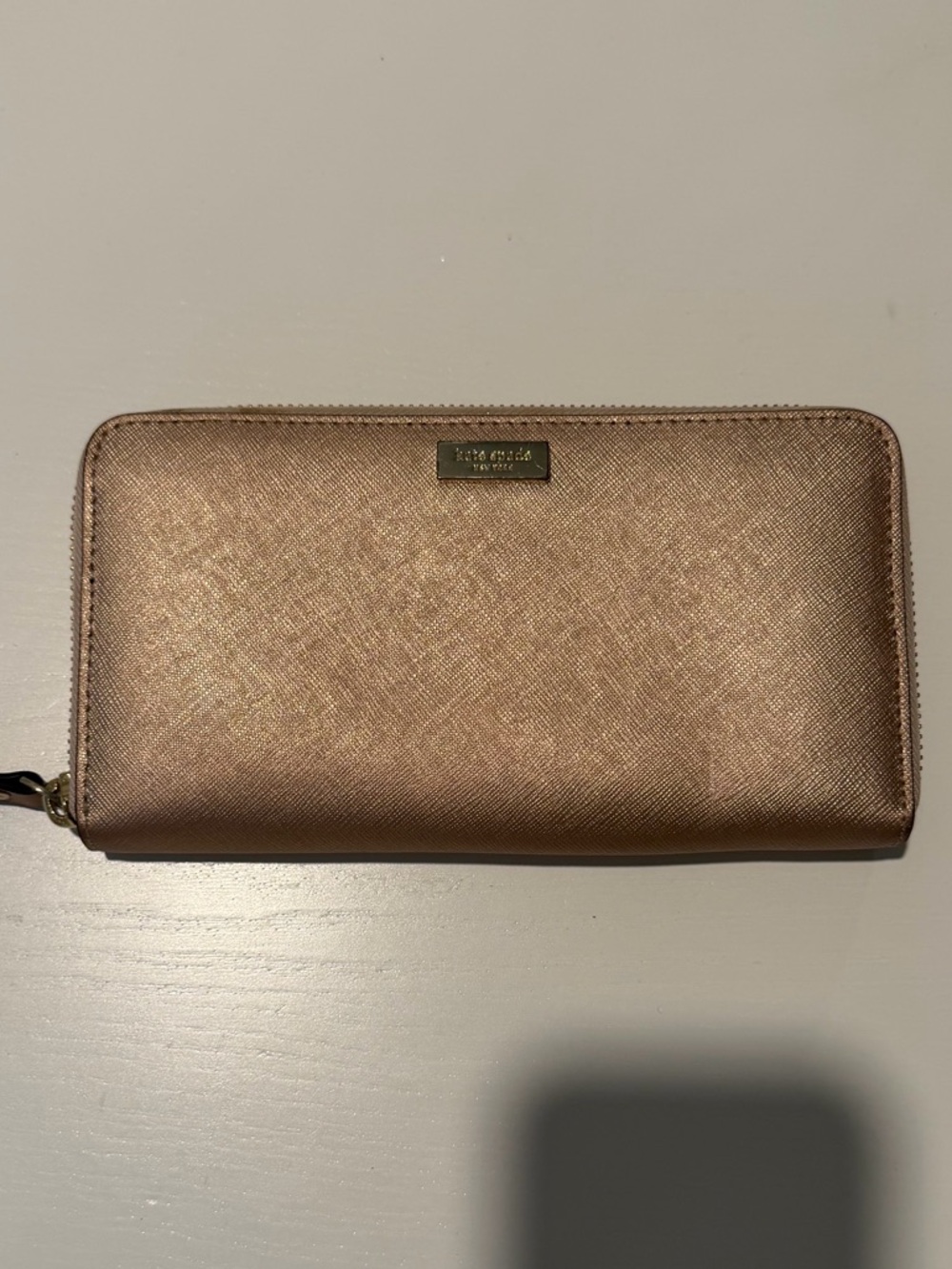 kate spade metallic rose gold zip wallet with gold logo